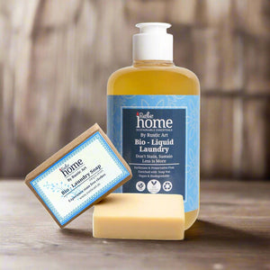Bottle and bar of Rustic Art laundry soap on a white background