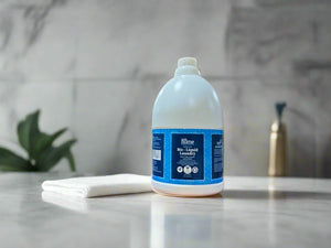 Large bottle of laundry detergent on a desk in an office setting