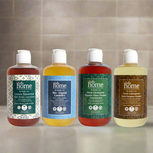 Four bottles of home cleaning products from the brand 'Home', including labels for each product.